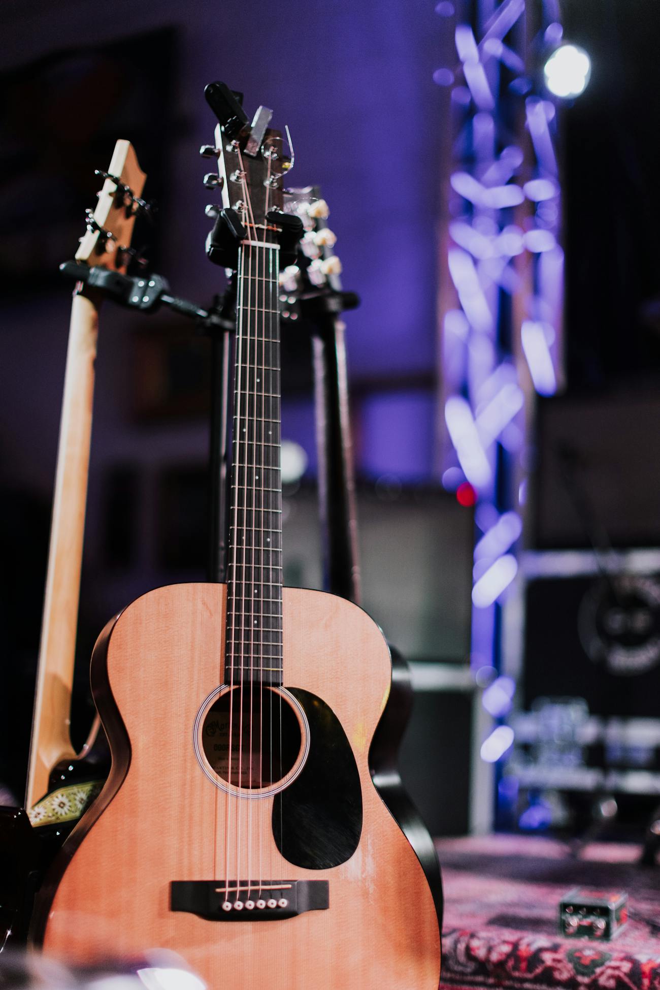 Acoustic guitar on stage with soft lighting