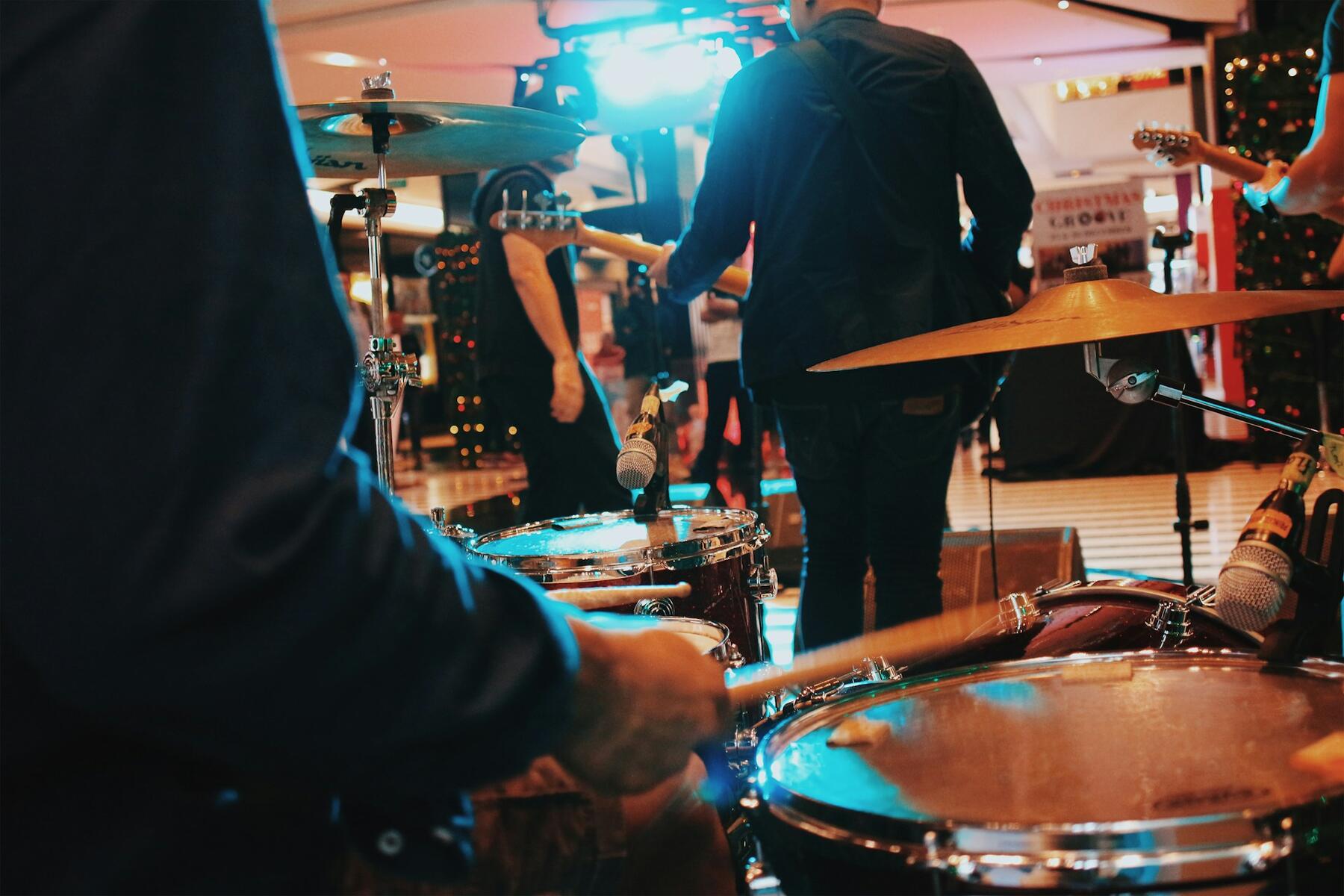 A group of people energetically playing drums together in a lively music
