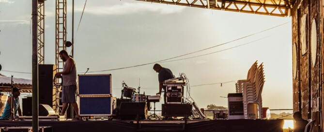 Live band setting up outdoor wedding stage