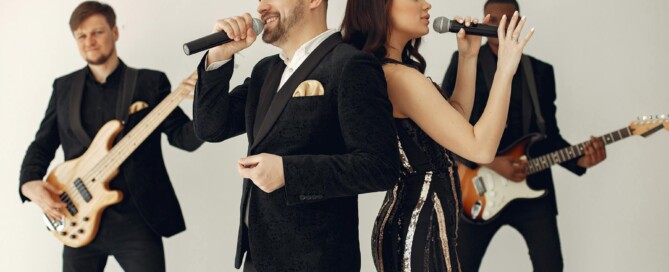 Live band singing with microphones in formal attire