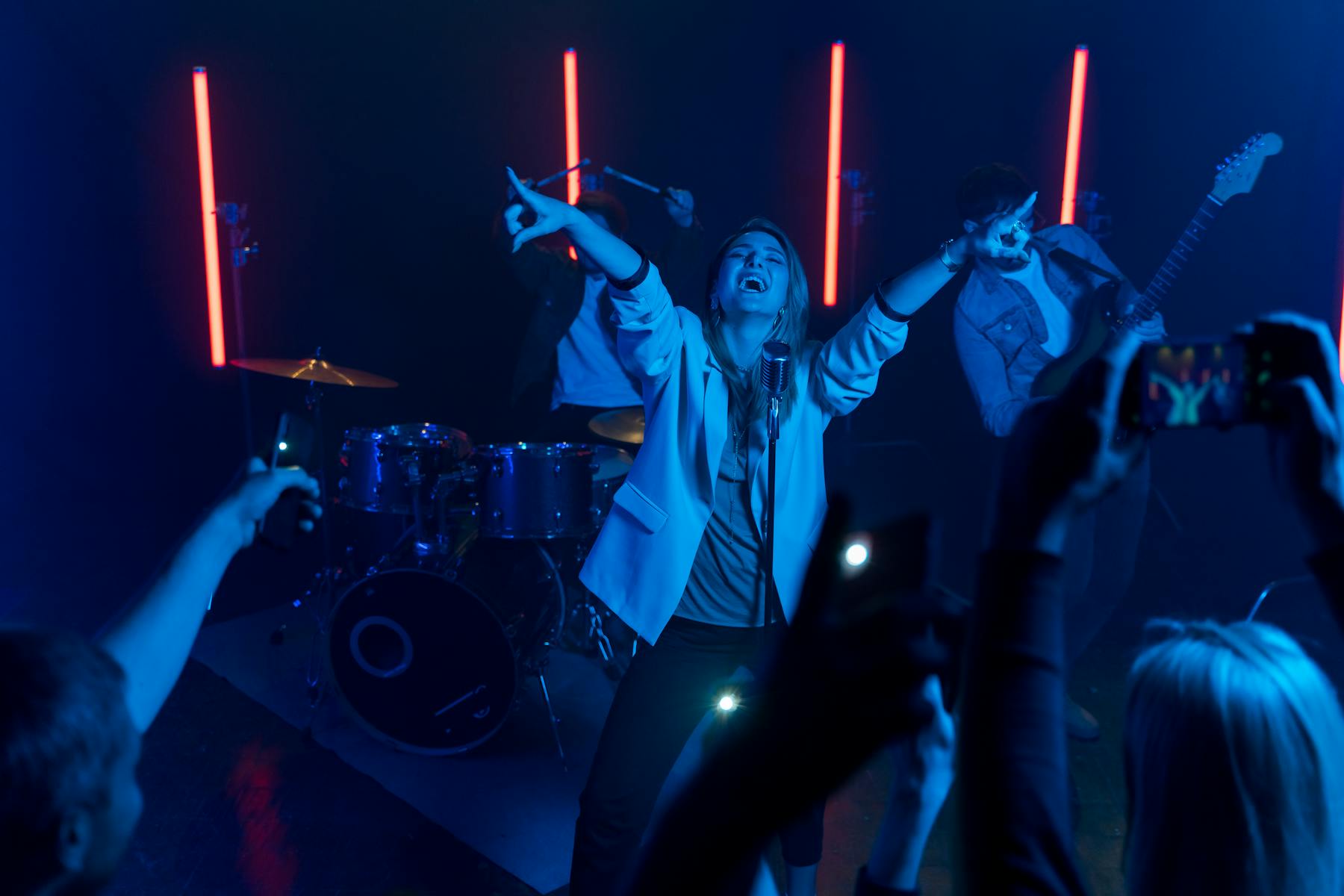 Concert singer performing on stage with audience and lights