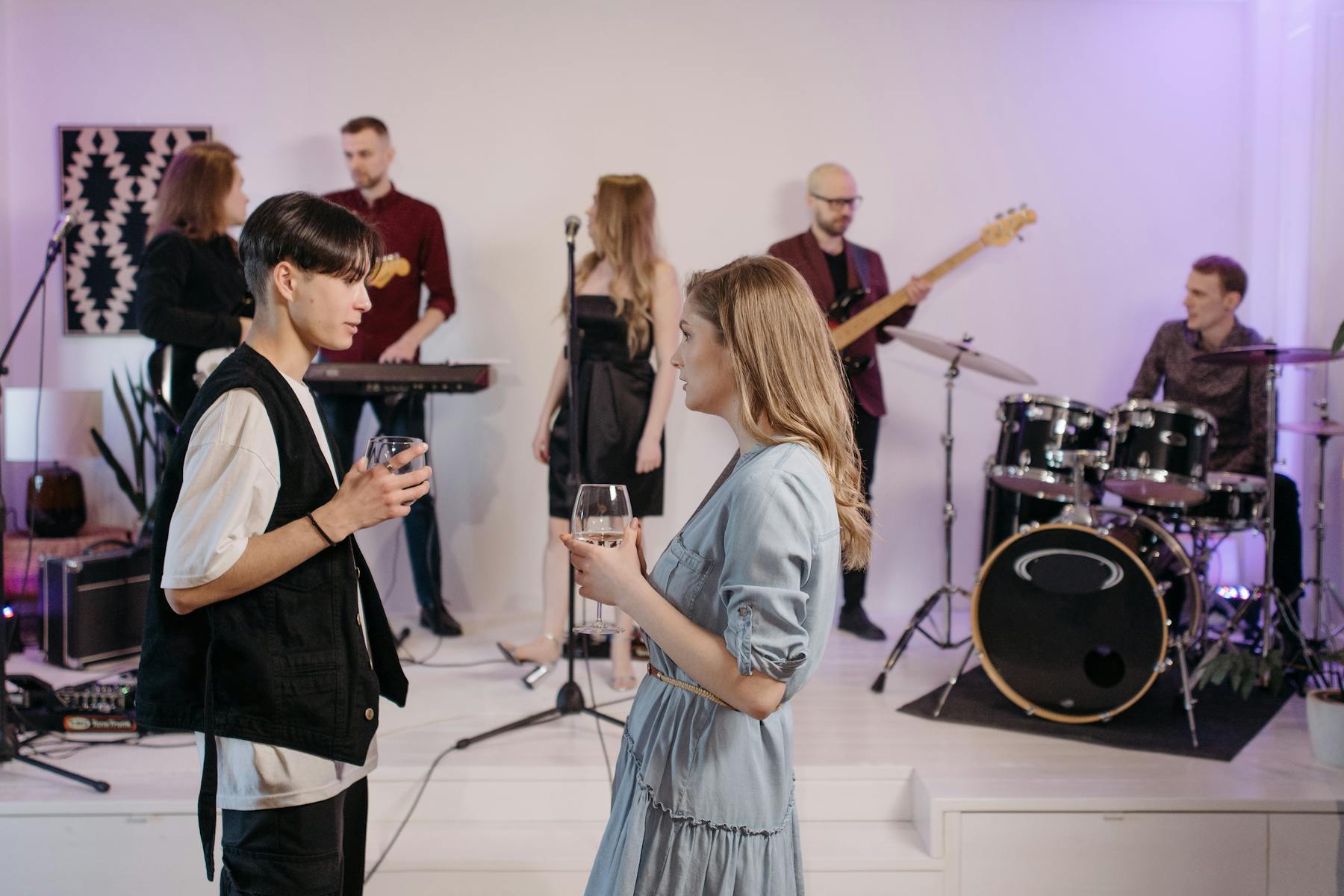 Guests chatting in front of a live band at an indoor event