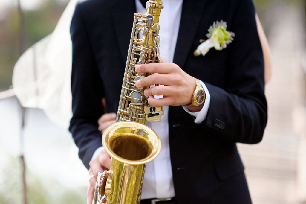 Playing saxophone A groom playing a saxophone